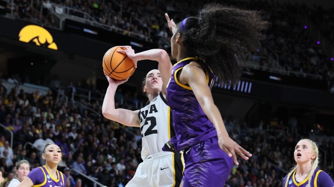 Angel Reese defends a shot from Caitlin Clark.