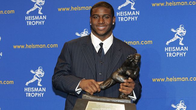 reggie bush holding his heisman trophy