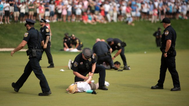Protestors are corralled at the Travelers Championship.