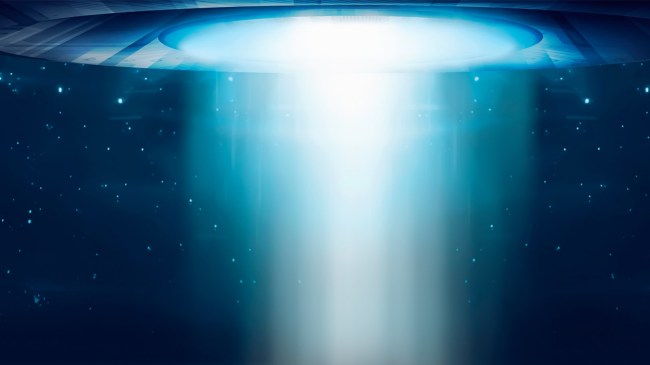 ufo shining light on the ground