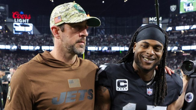 Aaron Rodgers and Davante Adams on the field after a game between the Jets and Raiders.