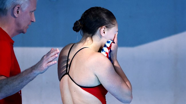 Alison Gibson reacts after hitting her feet on diving board during Olympic Games
