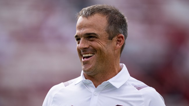 Shane Beamer smiles on the field before a South Carolina football game.
