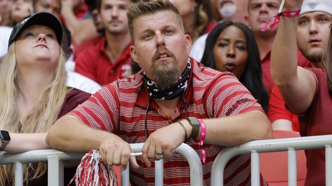 An Alabama football fan watches the action from the stands.