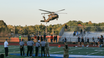 High School Football Players Fight For Loose Ball Dropped From Helicopter To Begin State Championship
