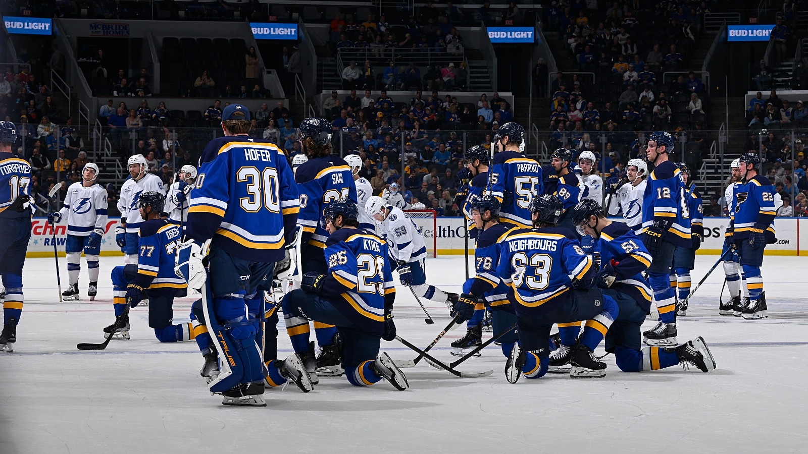 Tampa Bay Lightning and St. Louis Blues on the ice after Dylan Holloway injury