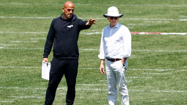 woody johnson and robert saleh on a practice field