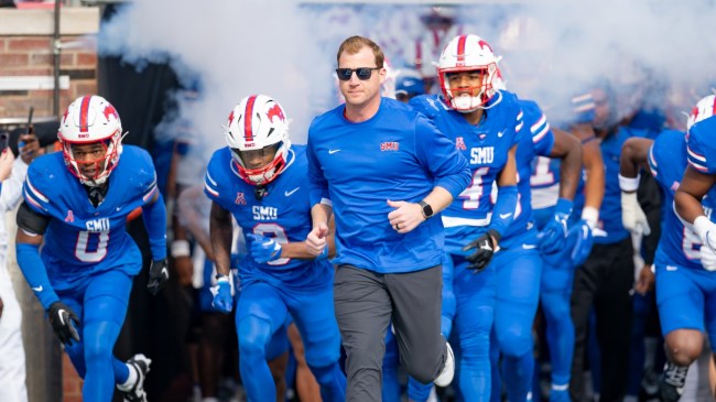 Head coach Rhett Lashlee leads the SMU football team onto the field.