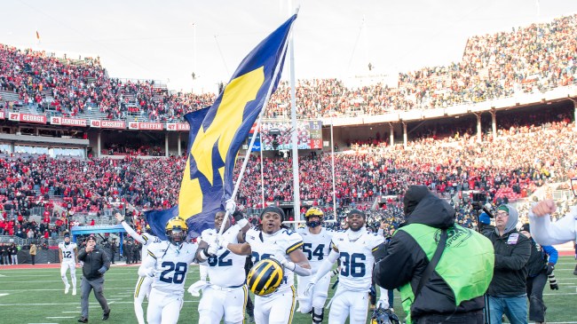 Michigan players with flag after beating Ohio State