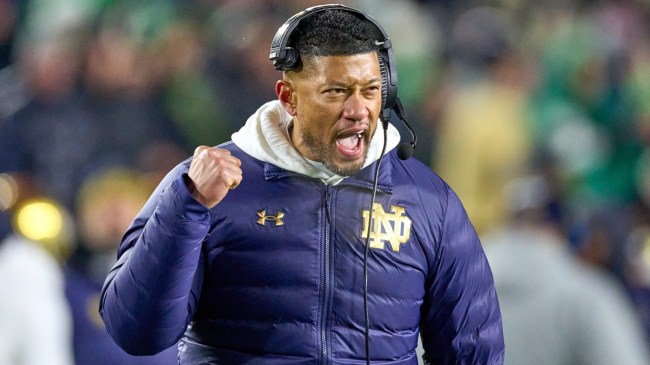 Notre Dame football coach Marcus Freeman celebrates on the sidelines.