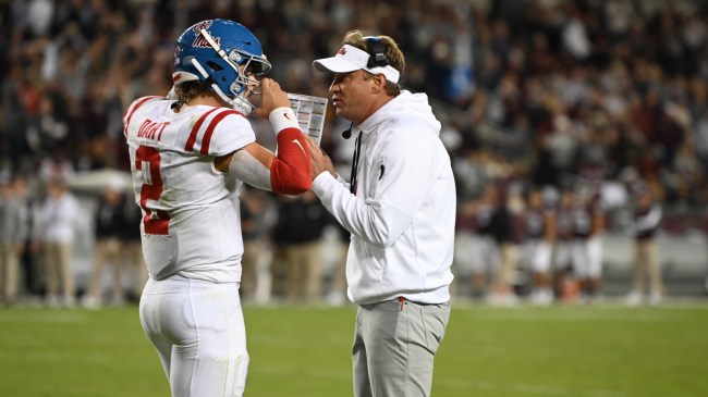 Ole Miss football coach Lane Kiffin speaking with QB Jaxson Dart.