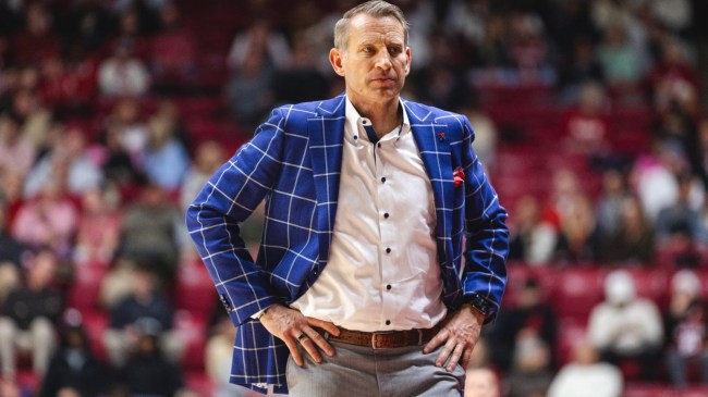 Alabama basketball coach Nate Oats stands on the court.
