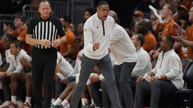 Texas basketball coach Rodney Terry celebrates on the sidelines.