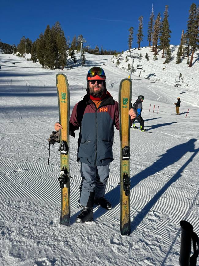 Brandon Wenerd holding Romp Skis at Mammoth Mountain, California