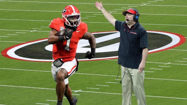 Georgia running back pictured beside football coach Kirby Smart.