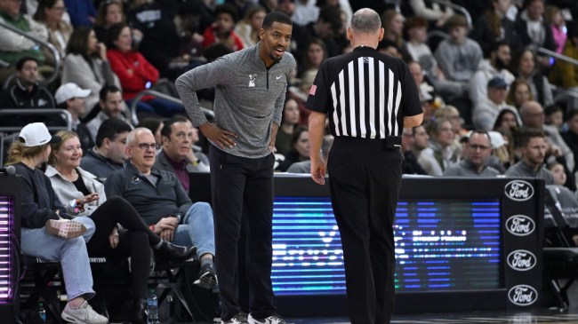 Providence basketball coach Kim English speaks to a referee.