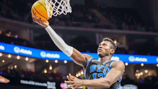 BYU basketball player Keba Keita lays the ball into the basket.