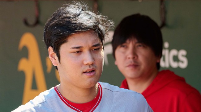 Shohei Ohtani and interpreter Ippei Mizuhara stand in the dugout