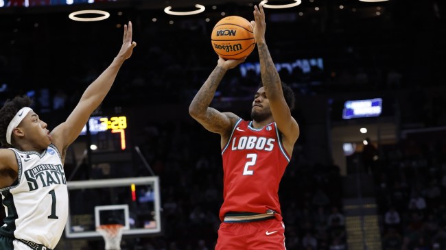 New Mexico guard Donovan Dent shoots over a Michigan State defender.