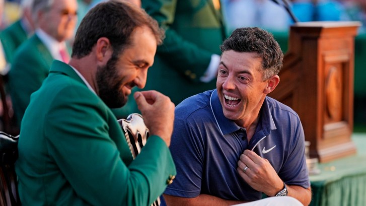 Masters champions Rory McIlroy and Scottie Scheffler share a moment after Rory won his first green jacket
