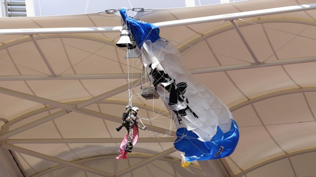 Parachuter hanging from roof at French rugby game