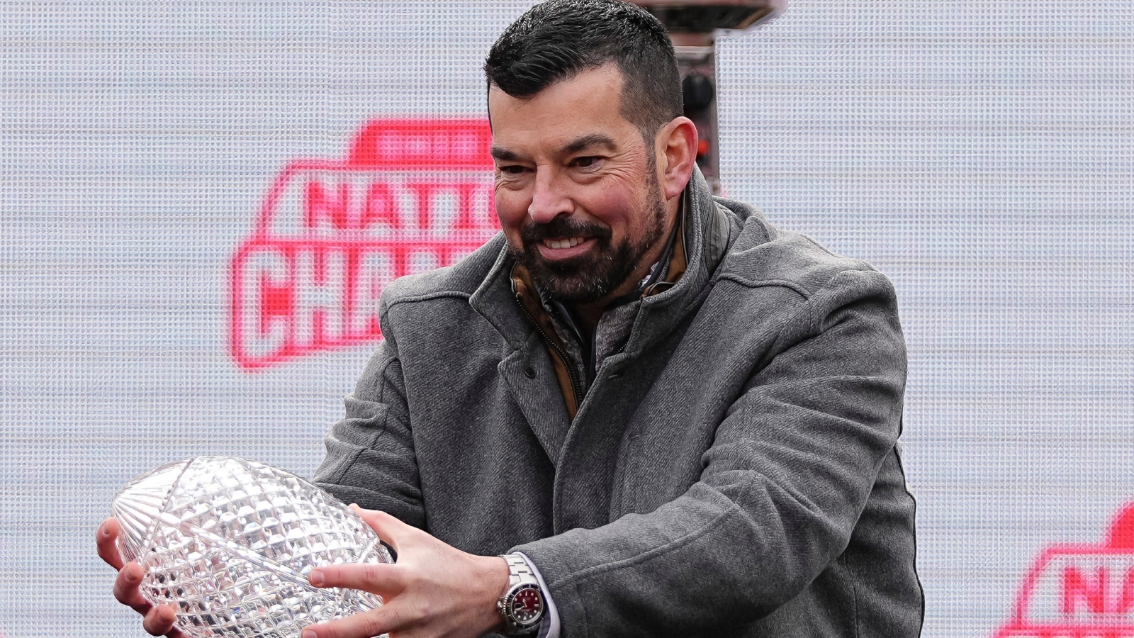 Ryan Day holds a national championship trophy.