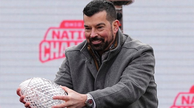 Ryan Day holds a national championship trophy.