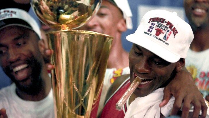 Michael Jordan wearing a three peat championship hat