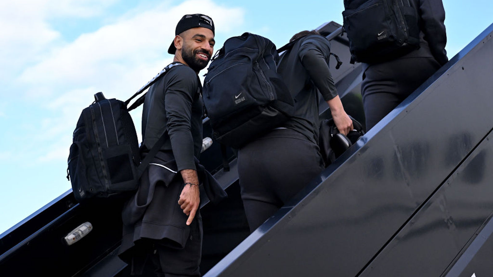 mo salah and liverpool boarding plane