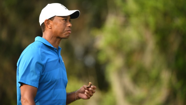 Tiger Woods eating a snack on the golf course