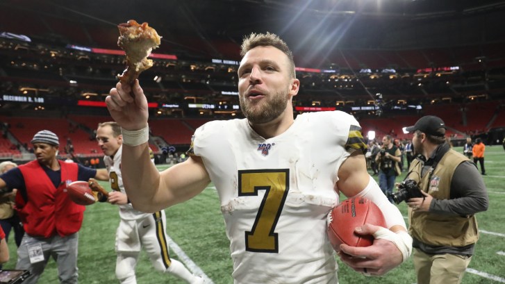 Taysom Hill holds a large turkey leg