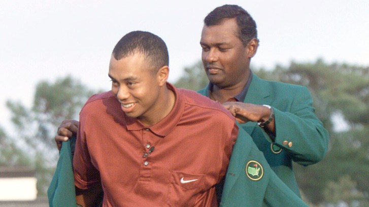Vijay Singh puts green jacket on Tiger Woods at The Masters